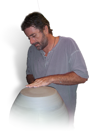 Photo of Miles Roberts at the pottery wheel.